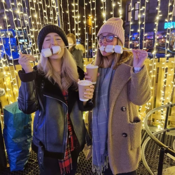 Two people enjoying roasted marshmallows
